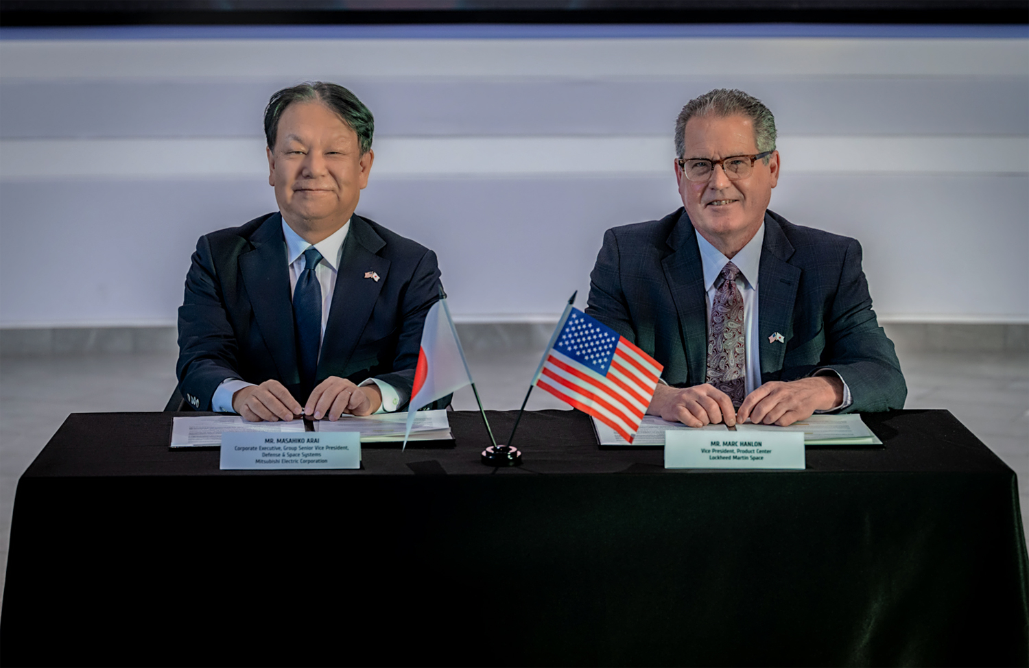 (from left) Masahiko Arai, Corporative Executive, Group Senior Vice President, Defense & Space Systems, Mitsubishi Electric, and Marc Hanlon, Vice President, Product Center, Lockheed Martin Space (Courtesy of Lockheed Martin)