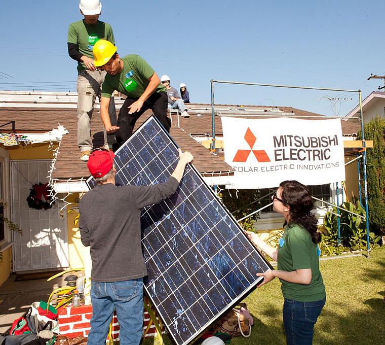 photo: Volunteers installing solar electric systems