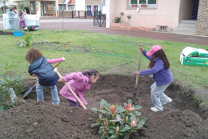photo: three little girls digging a hole for planting