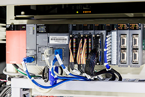 Base unit test equipment: one of the systems using the C Controller. The C Controller is used to control the test to check the input/output of the base unit and store test results in the production control database
